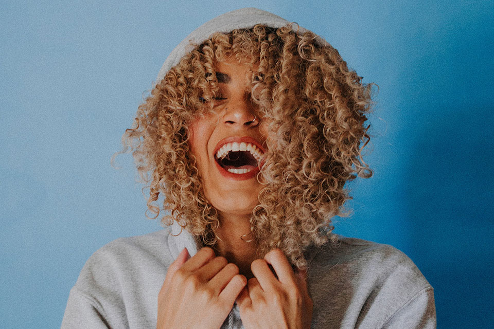 Woman with curly hair laughing