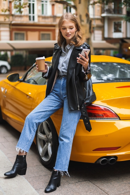 Automotive influencer taking selfie on yellow car