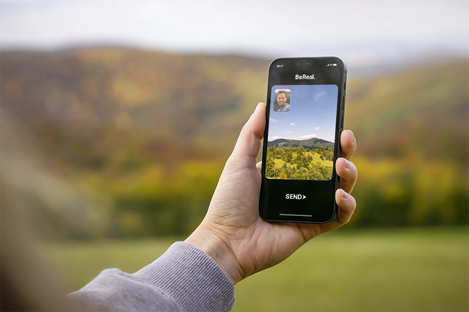 Someone holding a phone and making a BeReal post