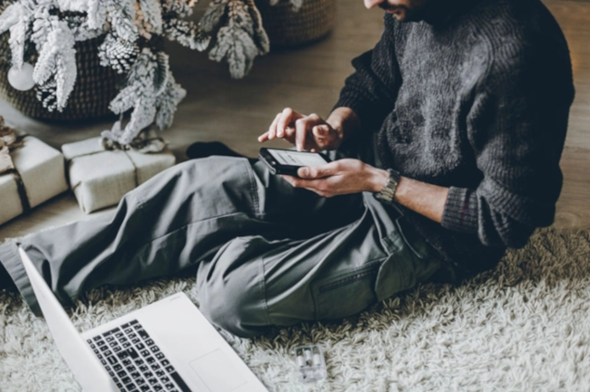 Man on his phone buying something on Black Friday demonstrating  Black Friday buying trends