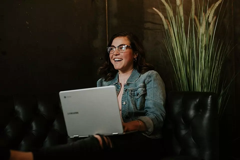 Woman on a computer researching earned media value