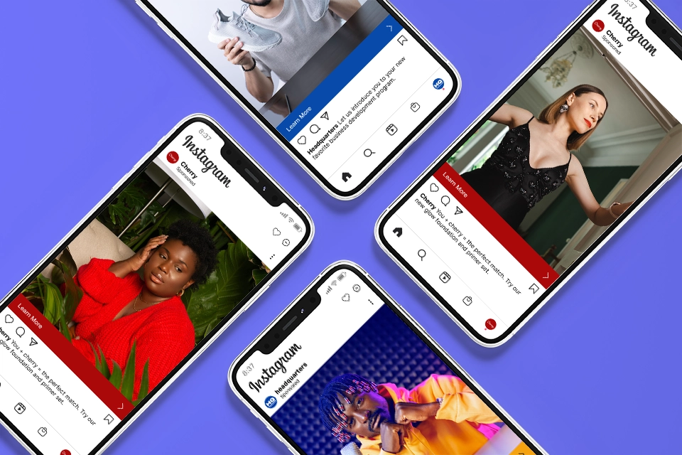 Four smartphones on a purple background with sponsored Instagram posts on them