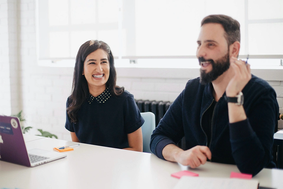 Two people working in influencer marketing jobs sitting at a table