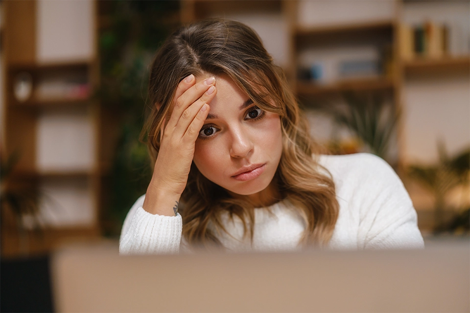 Stressed woman looking at a computer screen