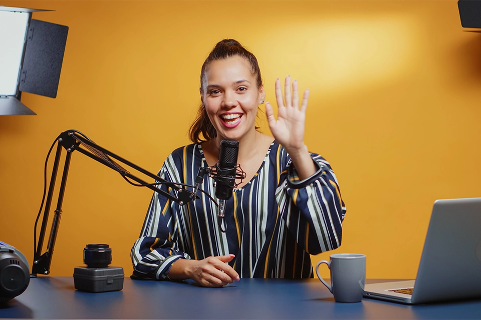 An influencer speaking into a microphone symbolizing someone who can help you answer "who is your target audience"