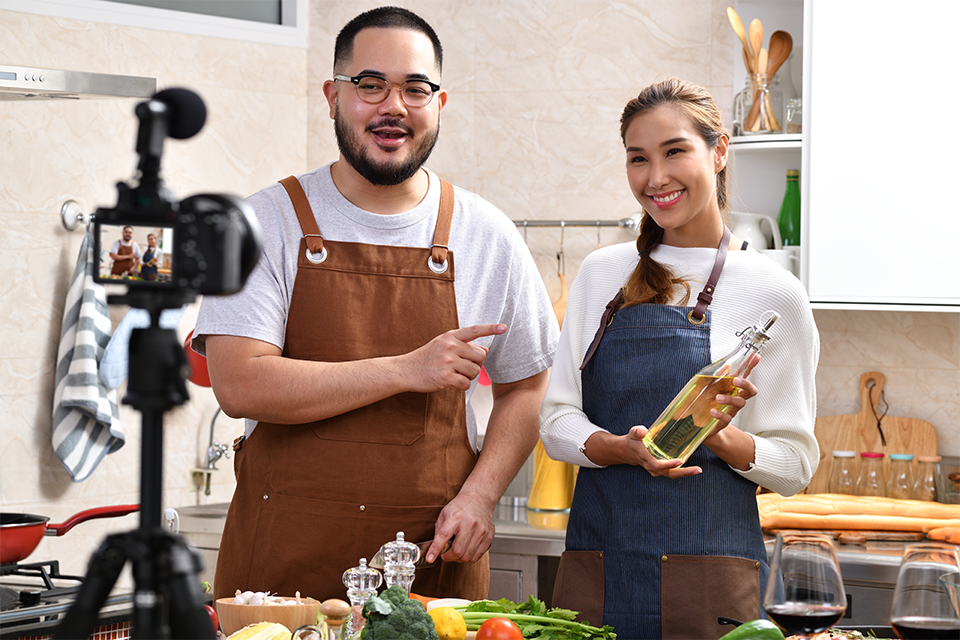 Two influencers recording themselves participating in food influencer marketing