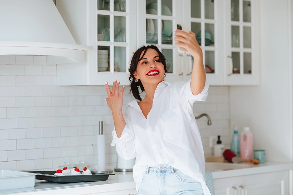 Woman taking selfie by baked goods