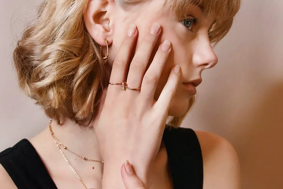 Woman wearing delicate gold jewelry